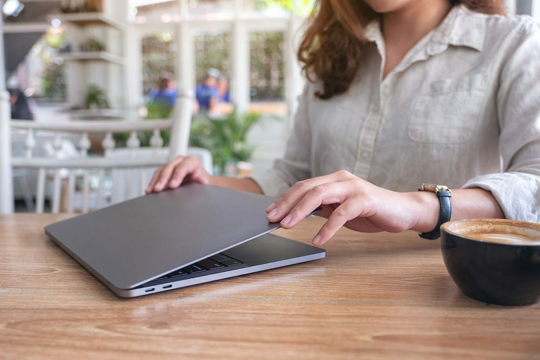 working woman taking a break, closing laptop